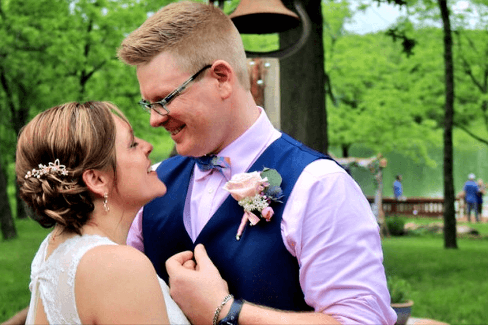 Young bride and groom embracing outdoors in the summer