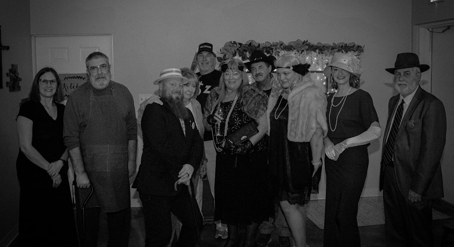 black and white photo of people dressed in character for a mystery dinner