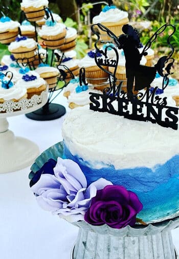 Wedding Cake with blue frosting and a fishing cake topper