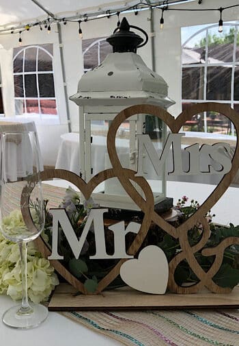 Mr. & Mrs wooden sign with a white lantern and champagne glass