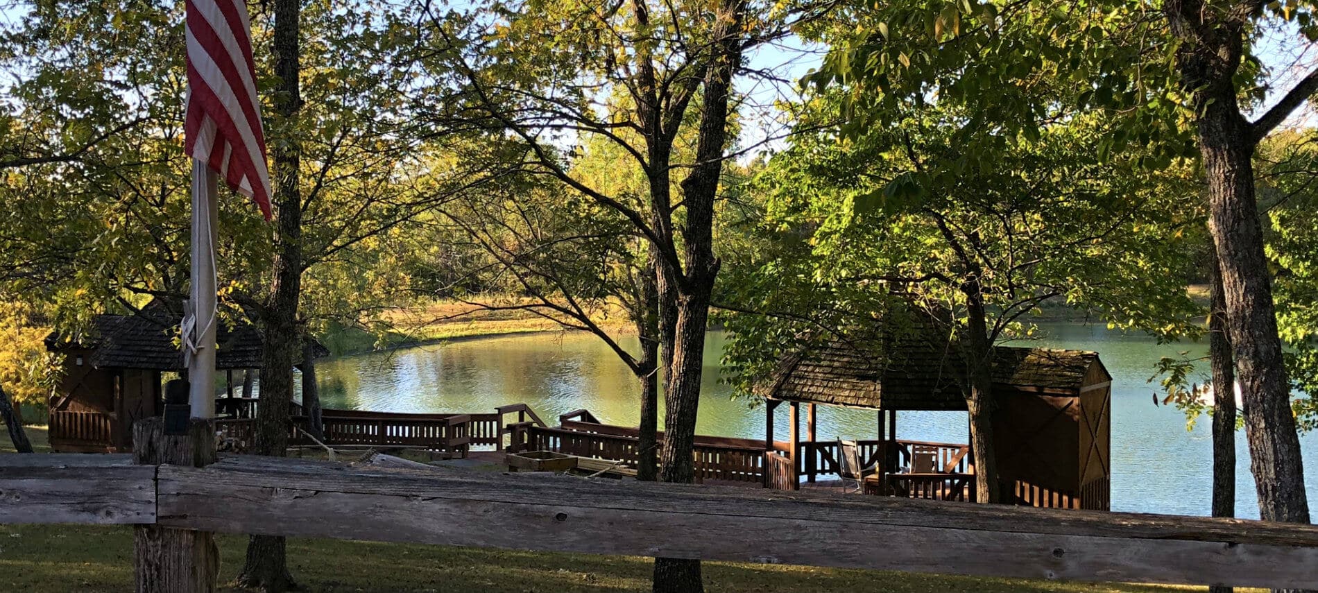 View of the pond and gazebos through the trees